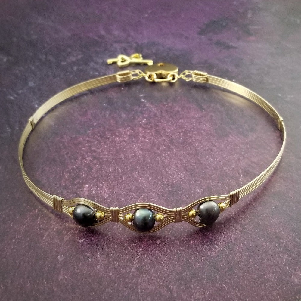 Luxurious gold surrounds large freshwater pearls in an exotic peacock color {blues and greens} in this submissive locking BDSM collar. It's bold, yet delicate and oh so feminine. Show your ownership or submission with beauty and grace.