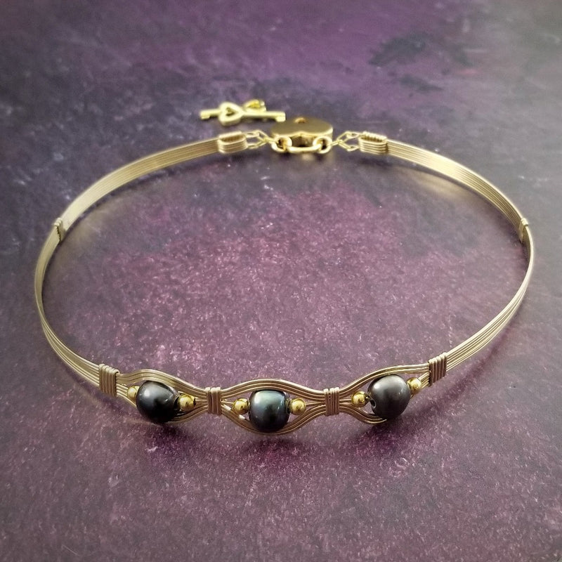 Luxurious gold surrounds large freshwater pearls in an exotic peacock color {blues and greens} in this submissive locking BDSM collar. It's bold, yet delicate and oh so feminine. Show your ownership or submission with beauty and grace.