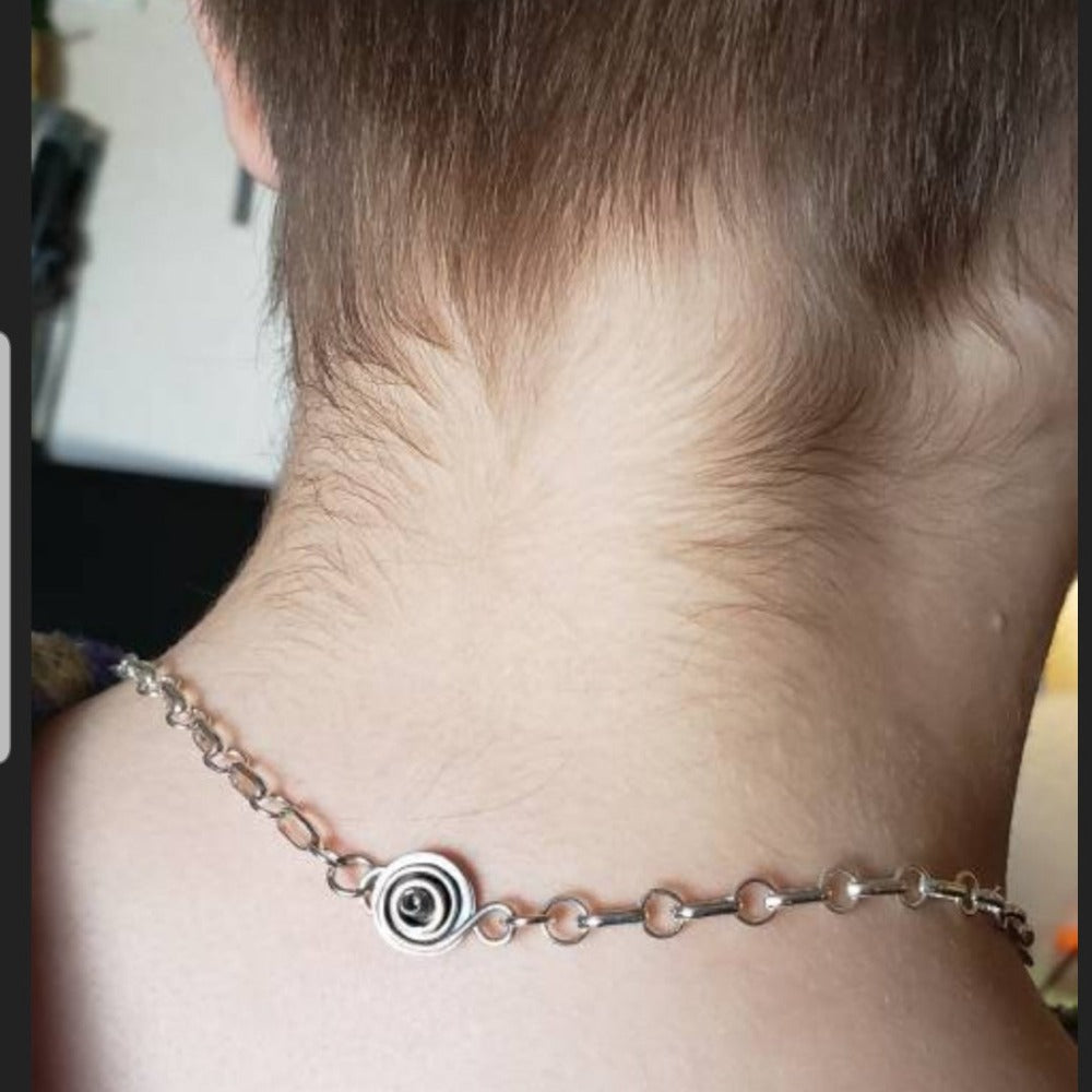 A handcrafted locking clasp / closure that uses a hex / allen screw, and small screw driver.