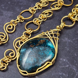  The focal pendant is a large oval cabochon set in a handcrafted wire wrapped gold frame