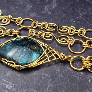  The focal pendant is a large oval cabochon set in a handcrafted wire wrapped gold frame