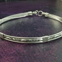 We've taken a fan favorite and revved it up with some silver accents. The 'INFATUATION' collection of submissive jewelry is sweetly feminine. Delicate with a soft flowing design that's perfect for todays sub, yet has a medieval touch to it. This submissive locking collar is hand crafted in a romantic floral pattern of solid sterling silver. A beautiful symbol of commitment or wedding gift.