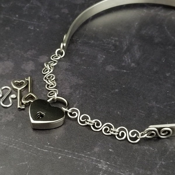 A submissive collar so unique, you'll be proud to wear this collar anywhere! It certainly doesn't 'look' like a BDSM locking collar. You'll treasure this piece! The solid sterling silver collar features White Moonstone cabochons and hand crafted Infinity symbols.