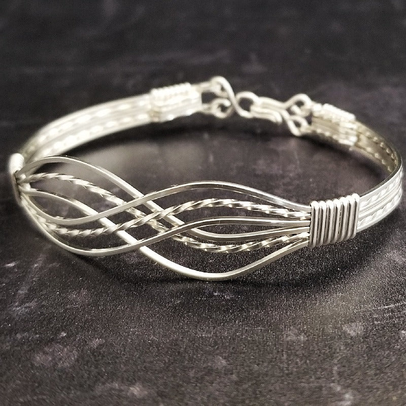 Symbolizes enduring love and commitment. Handcrafted in strands of both smooth and hand twisted precious metals. The bracelet can be locked for a beautifully discreet symbol of submission or ownership, or it can be created as a traditional bracelet.
