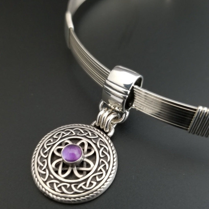 The Lodi locking submissive collar in sterling with Irish Good Luck medallion in amethyst. The collar can be worn alone or with collar enhancers.