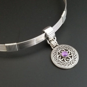 The Lodi locking submissive collar in sterling with Irish Good Luck medallion in amethyst. The collar can be worn alone or with collar enhancers.