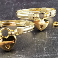 The JANUS collection of artisan BDSM jewelry is reminiscent of ancient Rome. These submissive handcuffs convert to beautiful day bracelets for discreet wear in the vanilla world. Unisex design is suitable for all. Hefty wire wrapped cuffs created with 14K gold-filled and accented with gold-filled accents.
