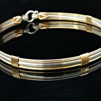 The JANUS collection of artisan BDSM jewelry is reminiscent of ancient Rome. The Janus Submissive Collar is a locking collar made of gleaming sterling silver with 14k gold filled accents