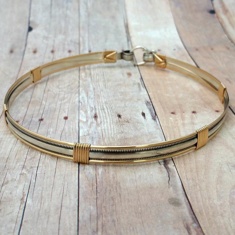 The JANUS collection of artisan BDSM jewelry is reminiscent of ancient Rome. The Janus Submissive Collar is a locking collar made of gleaming sterling silver with 14k gold filled accents
