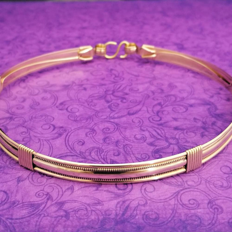 The Janus Submissive Collar is a locking collar made of luscious sterling silver with gleaming gold filled accents, so it's a statement of ownership, yet discreet enough to wear in the vanilla world. 