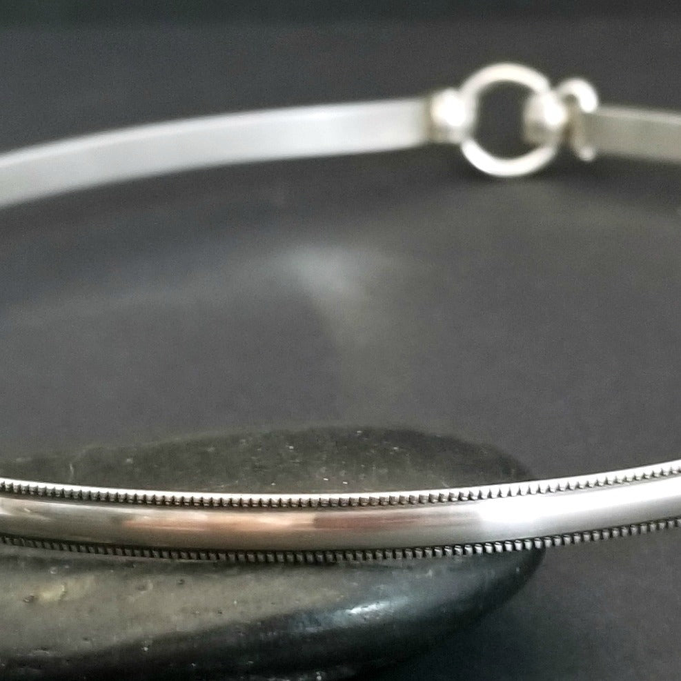 The Janus Submissive Collar is a locking collar made of luscious Sterling Silver, so it's a statement of ownership, yet discreet enough to wear in the vanilla world.