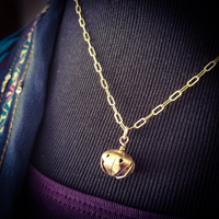 A submissive kitten bell handcrafted crafted with all the grace and discretion that My Secret Heart is known for. This artisan bell is hand sawn from a 14k yellow gold filled sheet, then torched, hammered and domed into an exquisite bell. Filled with stainless steel pellets for a delicate jingle.