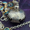 A locking submissive kitten bell handcrafted with all the grace and discretion that My Secret Heart is known for. The asymmetrical design features aquamarine, securely wrapped and incorporated into both steering and gold filled chains and links. 