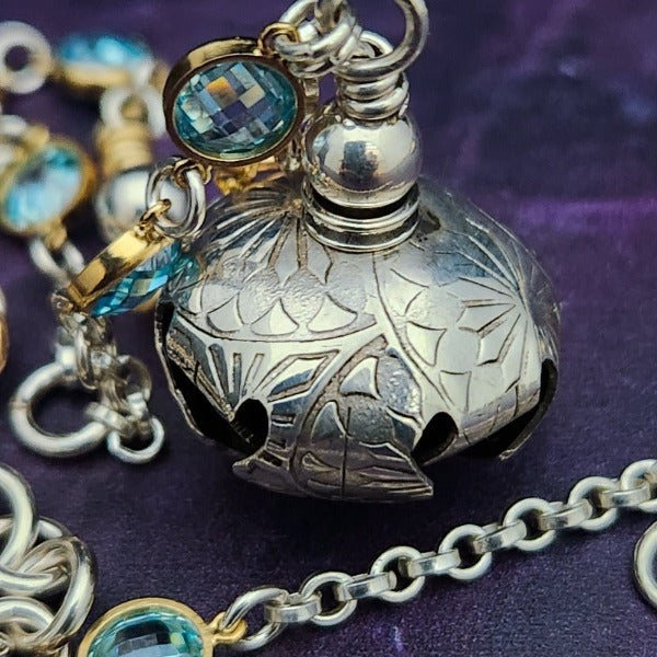 A locking submissive kitten bell handcrafted with all the grace and discretion that My Secret Heart is known for. The asymmetrical design features aquamarine, securely wrapped and incorporated into both steering and gold filled chains and links. 