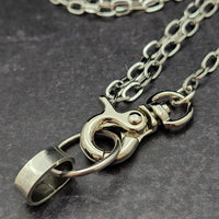 A sleek and simple chain collar of Stainless Steel gets it done. The handle is 10 inches of chain, so both small and large hands should fit easily. The 36 inch chain ends with a silver tone swivel trigger clip. Features a handcrafted sterling O Ring with a bail opening large enough to fit most all of our collars.