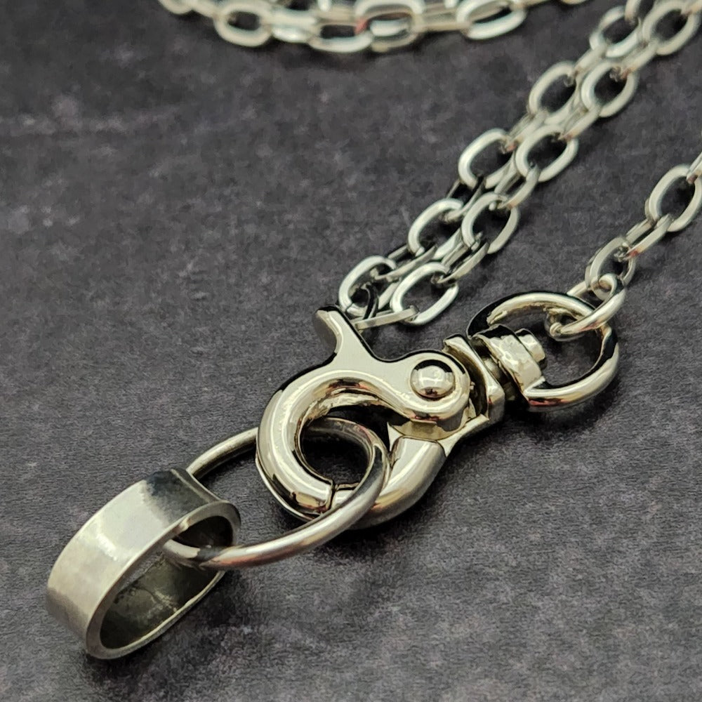 A sleek and simple chain collar of Stainless Steel gets it done. The handle is 10 inches of chain, so both small and large hands should fit easily. The 36 inch chain ends with a silver tone swivel trigger clip. Features a handcrafted sterling O Ring with a bail opening large enough to fit most all of our collars.