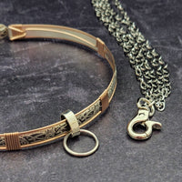 A sleek and simple chain collar of Stainless Steel gets it done. The handle is 10 inches of chain, so both small and large hands should fit easily. The 36 inch chain ends with a silver tone swivel trigger clip. Features a handcrafted sterling O Ring with a bail opening large enough to fit most all of our collars.