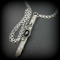An artisan gemstone necklace with a kinky secret!  The sterling silver pendant cages a sleek and sexy vibrator. So discreet, no one will ever guess. Think of all the fun you can have with this wicked little toy! 