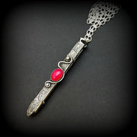 An artisan gemstone necklace with a kinky secret!  The sterling silver pendant cages a sleek and sexy vibrator. So discreet, no one will ever guess. Think of all the fun you can have with this wicked little toy! 