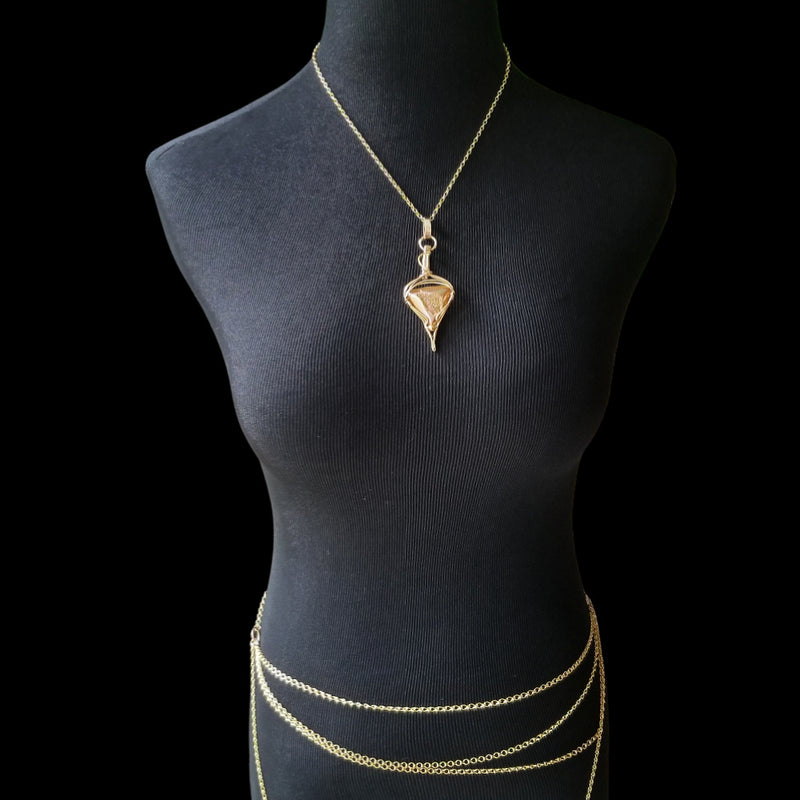 An incredibly luxurious look for a submissive collar. A triangular cut Gold Window Druzy is encased in a gold wire wrapped pendant that can be worn alone or slid onto most of our submissive collars. Featuring stunning open lattice work and a 14k gold filled chain that can be worn with a traditional clasp, or locked with a lock and key.