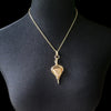 An incredibly luxurious look for a submissive collar. A triangular cut Gold Window Druzy is encased in a gold wire wrapped pendant that can be worn alone or slid onto most of our submissive collars. Featuring stunning open lattice work and a 14k gold filled chain that can be worn with a traditional clasp, or locked with a lock and key.