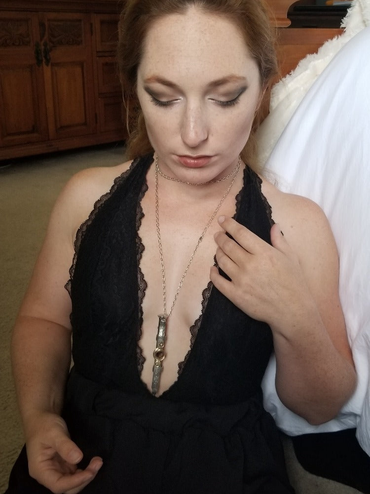 An BDSM gemstone necklace with a kinky secret. The ultimate luxury, this beauty is unlike any jewelry you've seen! The sterling silver cage holds a sleek and sexy stainless steel vibrator. So discreet, no one will ever guess. 