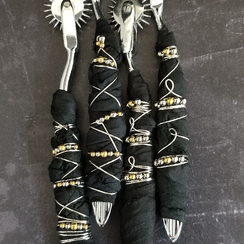 Artisan pin wheels are stainless steel Wheel, hand wrapped with luxurious Black Sari Silk and embellished with wire and mixed metal beads. An absolute must for your toy box!