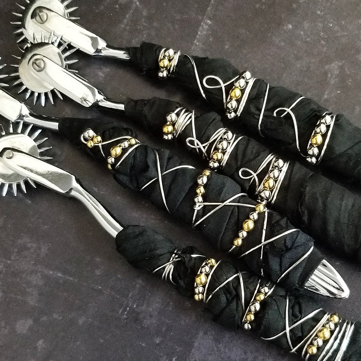 Artisan pin wheels are stainless steel Wheel, hand wrapped with luxurious Black Sari Silk and embellished with wire and mixed metal beads. An absolute must for your toy box!