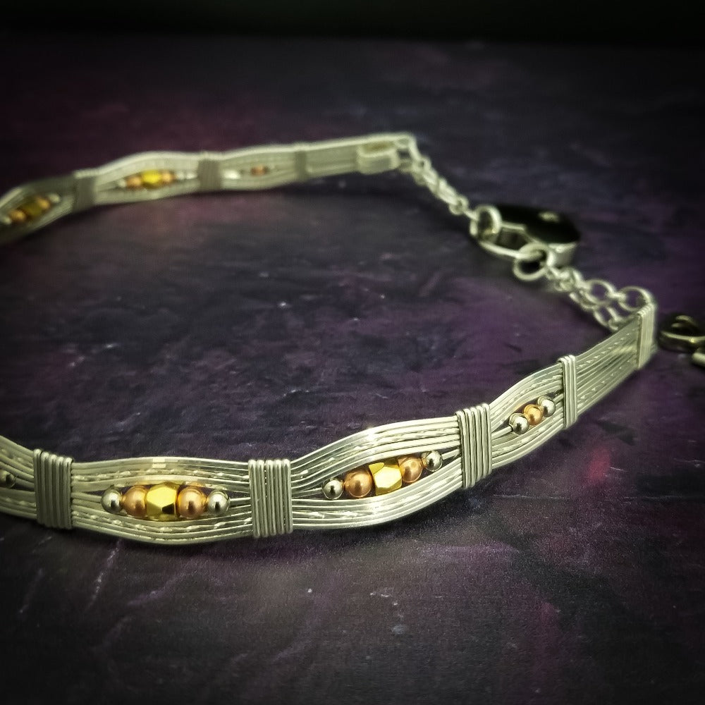 Bold and dramatic, and oh so sexy, this BDSM locking submissive collar will get plenty of attention. Yet it's so totally discreet, no one will ever know. Perfect statement of ownership for kittens, subs and slaves.   This wire wrapped collar is created in sterling silver, and has faceted sterling, 14k yellow and rose gold filled beads incorporated into the collar. With it's rounded, hand sculpted shape, this collar is very comfortable.   