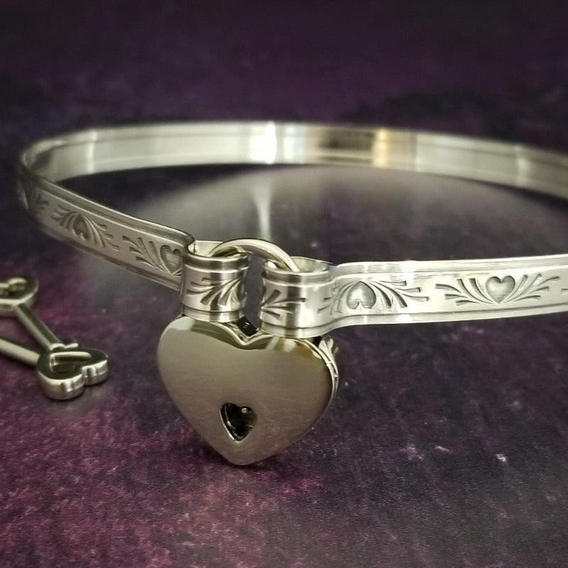 Sterling Silver BDSM Locking submissive collar symbolic of our crazy, chaotic hearts. Pretty for days, yet turns naughty when locked.The handcrafted sterling silver 'day clasp' offers discreet day wear, while the padlock allows for the jewelry to be transformed into a unique and stunning submissive piece. The locked collar is symbolic of chaotic hearts and can be worn in the front or back.