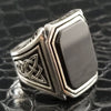 A signet style ring in sterling silver with an octagon-cut black onyx cabochon. Beautiful details include Celtic knots and beading on the top and bottom edges of the bezel.