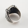 A signet style ring in sterling silver with an octagon-cut black onyx cabochon. Beautiful details include Celtic knots and beading on the top and bottom edges of the bezel.