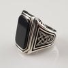 A signet style ring in sterling silver with an octagon-cut black onyx cabochon. Beautiful details include Celtic knots and beading on the top and bottom edges of the bezel.