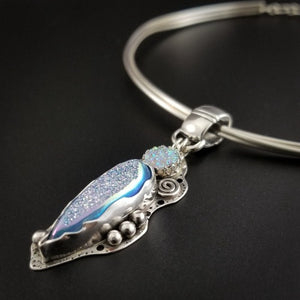 Teardrop shaped window druzy in aqua titanium and 8mm round white druzy set into handcrafted Sterling bezel. Embellished with handmade silver spirals and spheres.