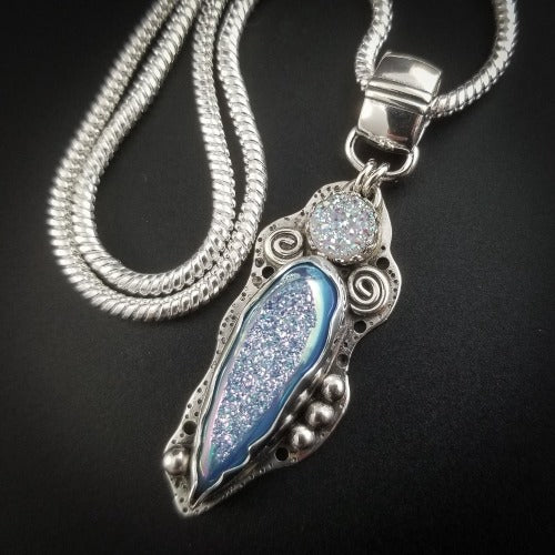 Teardrop shaped window druzy in aqua titanium and 8mm round white druzy set into handcrafted Sterling bezel. Embellished with handmade silver spirals and spheres.