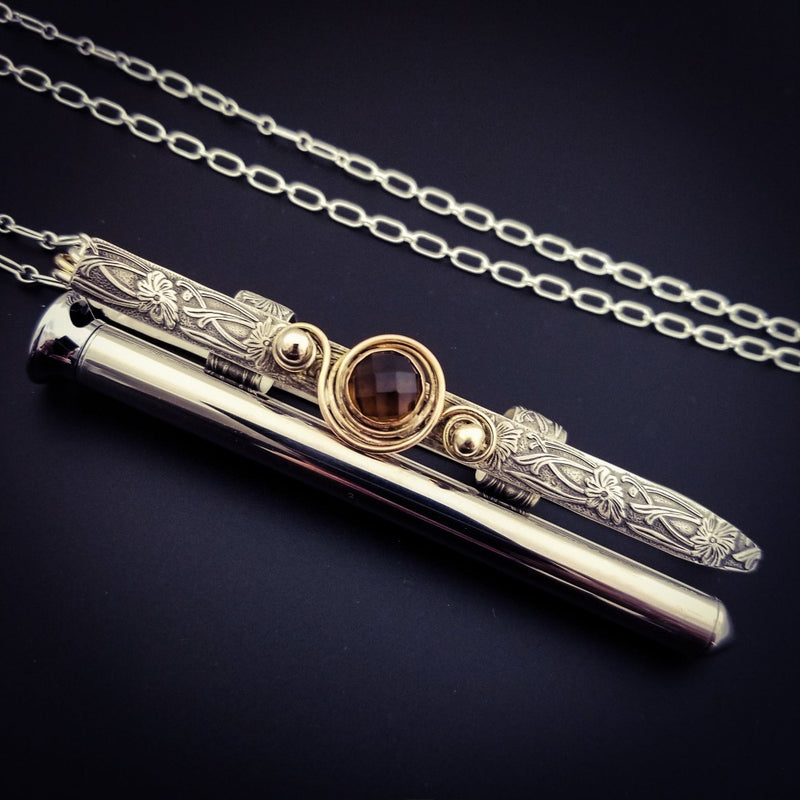 An BDSM gemstone necklace with a kinky secret. The ultimate luxury, this beauty is unlike any jewelry you've seen! The sterling silver cage holds a sleek and sexy stainless steel vibrator. So discreet, no one will ever guess. 