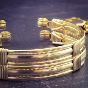 The JANUS collection of artisan BDSM jewelry is reminiscent of ancient Rome. These submissive handcuffs convert to beautiful day bracelets for discreet wear in the vanilla world. Unisex design is suitable for all. Hefty wire wrapped cuffs created with 14K gold-filled and accented with gold-filled accents.
