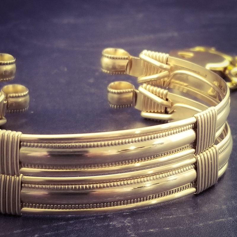 The JANUS collection of artisan BDSM jewelry is reminiscent of ancient Rome. These submissive handcuffs convert to beautiful day bracelets for discreet wear in the vanilla world. Unisex design is suitable for all. Hefty wire wrapped cuffs created with 14K gold-filled and accented with gold-filled accents.