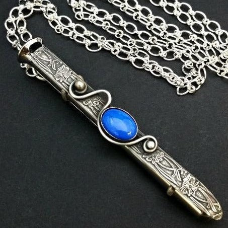 An artisan gemstone necklace with a kinky secret!  The sterling silver pendant cages a sleek and sexy vibrator. So discreet, no one will ever guess. Think of all the fun you can have with this wicked little toy! 
