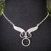 An locking, soft collar for your angel. This angel wing collar pays homage to your BDSM D/s lifestyle and has an O ring attached. Can be worn locked, or with a traditional clasp for discretion. Created with sterling silver chain, suitable for everyone, everyday. Do you think anyone will know what the classic 'Story of O' ring is for??