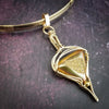 An incredibly luxurious look for a submissive collar. A triangular cut Gold Window Druzy is encased in a gold wire wrapped pendant that can be worn alone or slid onto most of our submissive collars. Featuring stunning open lattice work and a 14k gold filled chain that can be worn with a traditional clasp, or locked with a lock and key.