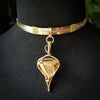 An incredibly luxurious look for a submissive collar. A triangular cut Gold Window Druzy is encased in a gold wire wrapped pendant that can be worn alone or slid onto most of our submissive collars. Featuring stunning open lattice work and a 14k gold filled chain that can be worn with a traditional clasp, or locked with a lock and key.