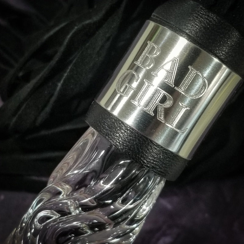 Achieve the ideal combination of bliss and agony with this BDSM Flogger, crafted of Black Suede and Glass. This timeless impact toy is stylish, opulent, and made with great attention to detail. Customize it your way and experience the range of sensations that come with S&M play from gentle warmth to hard hits. Can be engraved / monogrammed. By My Secret Heart Studios