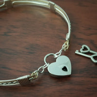 Sterling submissive collar that is discreet for daytime, yet kinky for playtime. The Celtic inspired design features a rope pattern, with accent lines of sterling and 14k gold filled, all wrapped together with sterling wraps. 