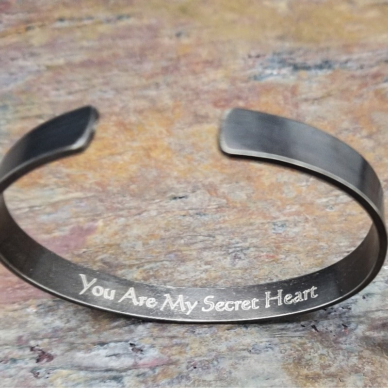 Share a secret. Ancient looking fonts create unique cuffs with a secret message. The outside inscription is Kanji symbols. Traditional Cuff with gap. All Sterling Silver, heavily oxidized. Message: You Are My Secret Heart
