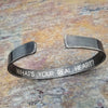 Share a secret. Ancient looking fonts create a unique cuff with a secret message. The outside inscription is Kanji Symbols.