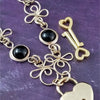 Made a bold statement of your Dominant / submissive lifestyle. The CELTIC PRIESTESS locking submissive collar features chain links inspired by Celtic knots, all created entirely by hand. Embellished with 2 natural Black Onyx gemstone cabochons. My Secret Studios 001