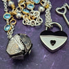 A locking submissive kitten bell handcrafted with all the grace and discretion that My Secret Heart is known for. The asymmetrical design features aquamarine, securely wrapped and incorporated into both steering and gold filled chains and links. 