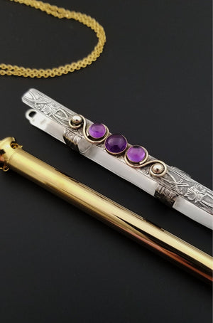 An BDSM gemstone necklace with a kinky secret. The ultimate luxury, this beauty is worthy of any Princess. Heck ... even a Queen! The sterling silver cage holds a sleek and sexy 24k gold plated vibrator. So discreet, no one will ever guess