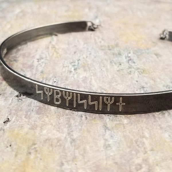 Share a secret. Rune font creates a unique collar with a secret message. The outside inscription is engraved in Rune symbols for Submissive, and the inside is engraved  with your choice of inscription